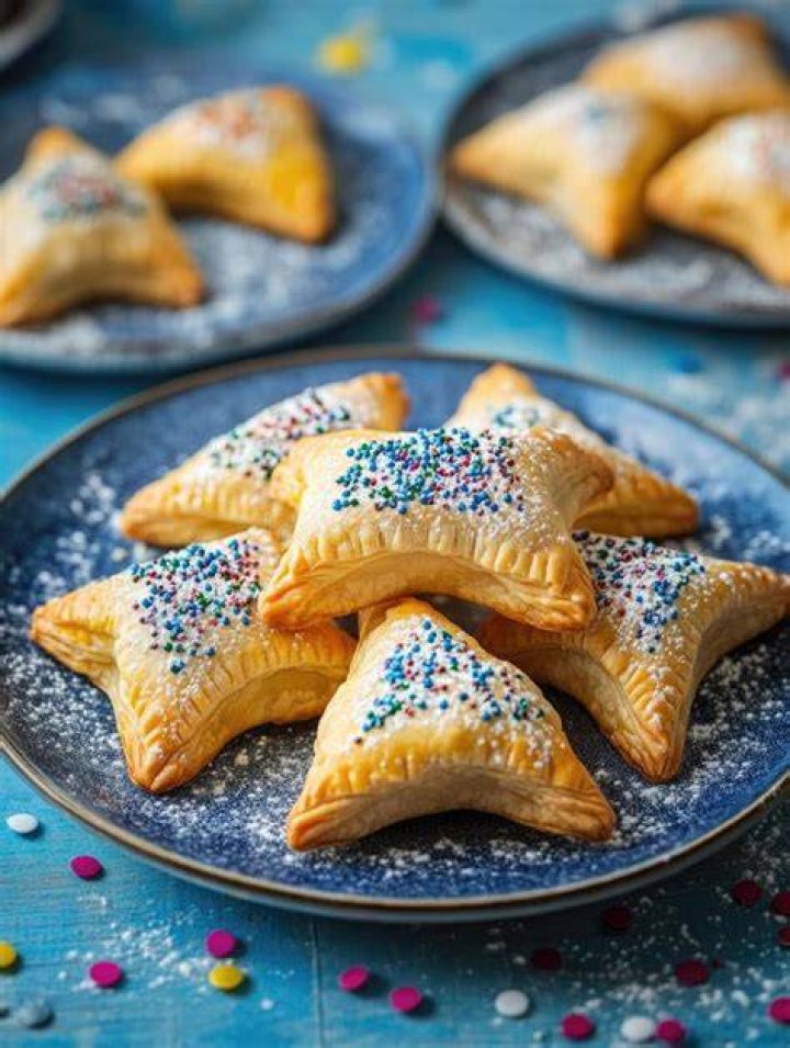 Blue plate topped with sprinkle sugar cookies.