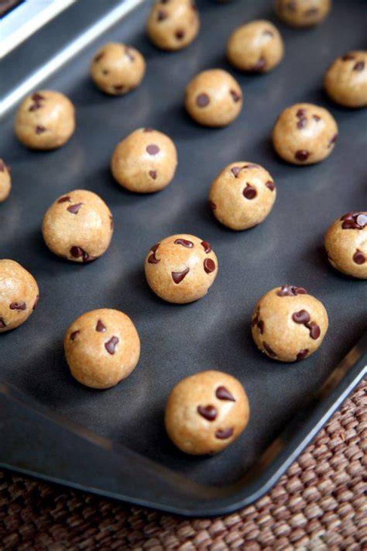 Cookie dough balls on a baking sheet.